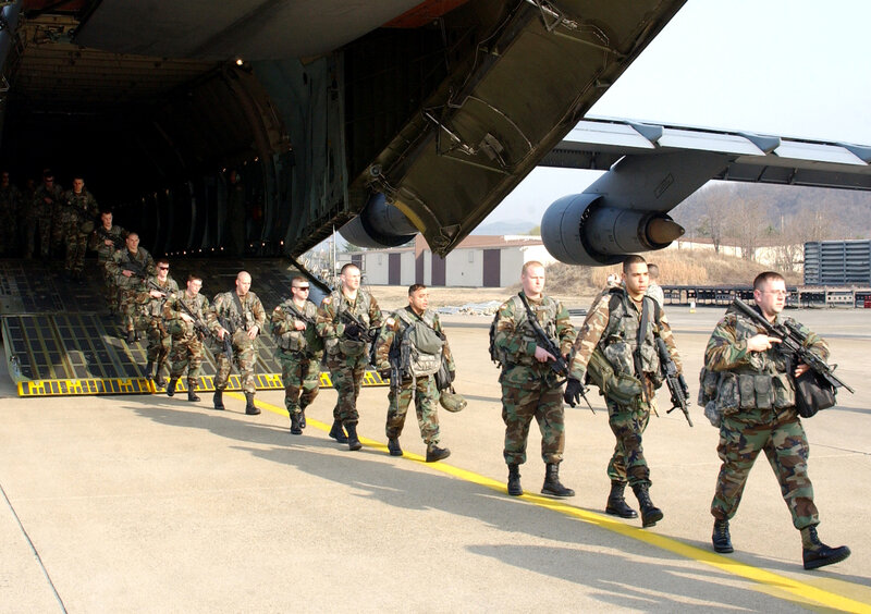 Soldiers disembarking from transport aircraft