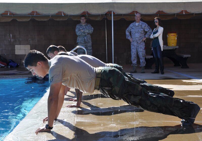 Soldiers doing push-ups by pool