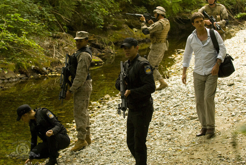 Soldiers escorting man through forest