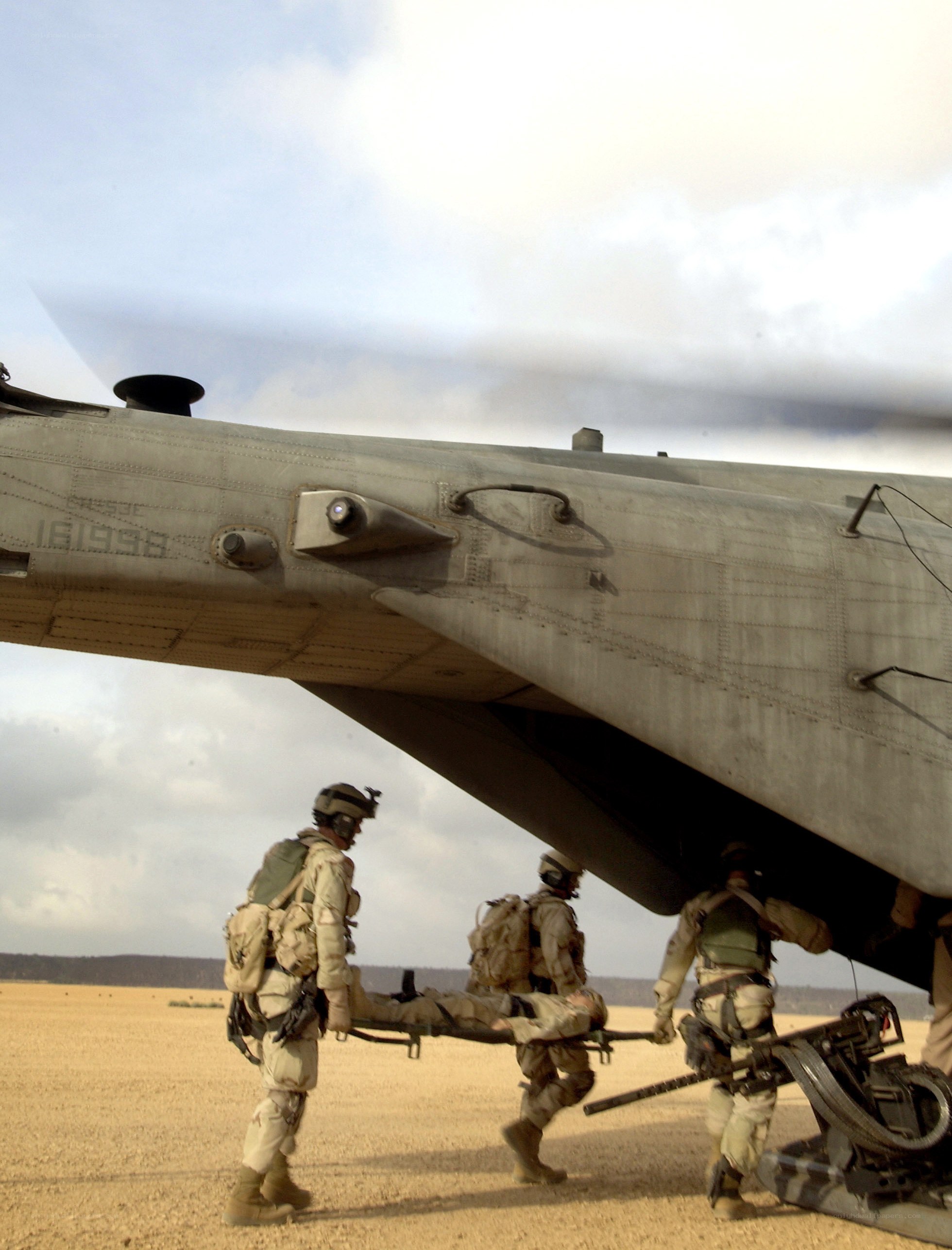 Soldiers evacuating wounded from helicopter