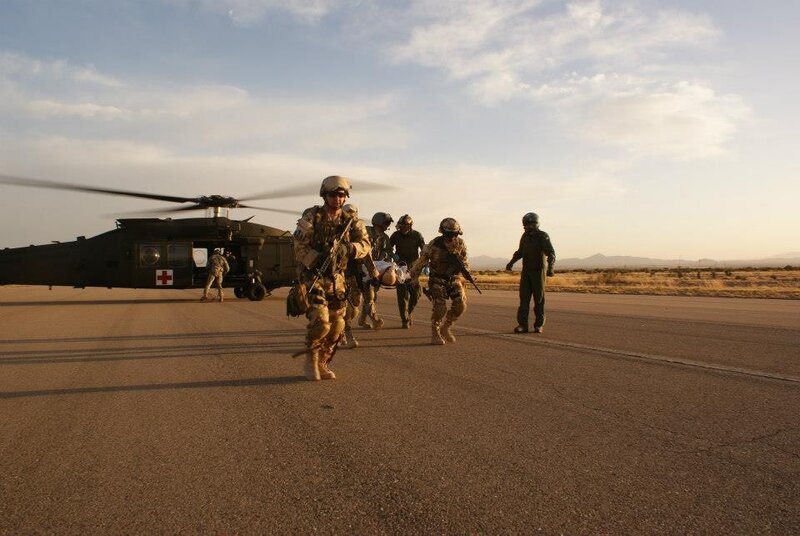 Soldiers evacuating wounded from helicopter