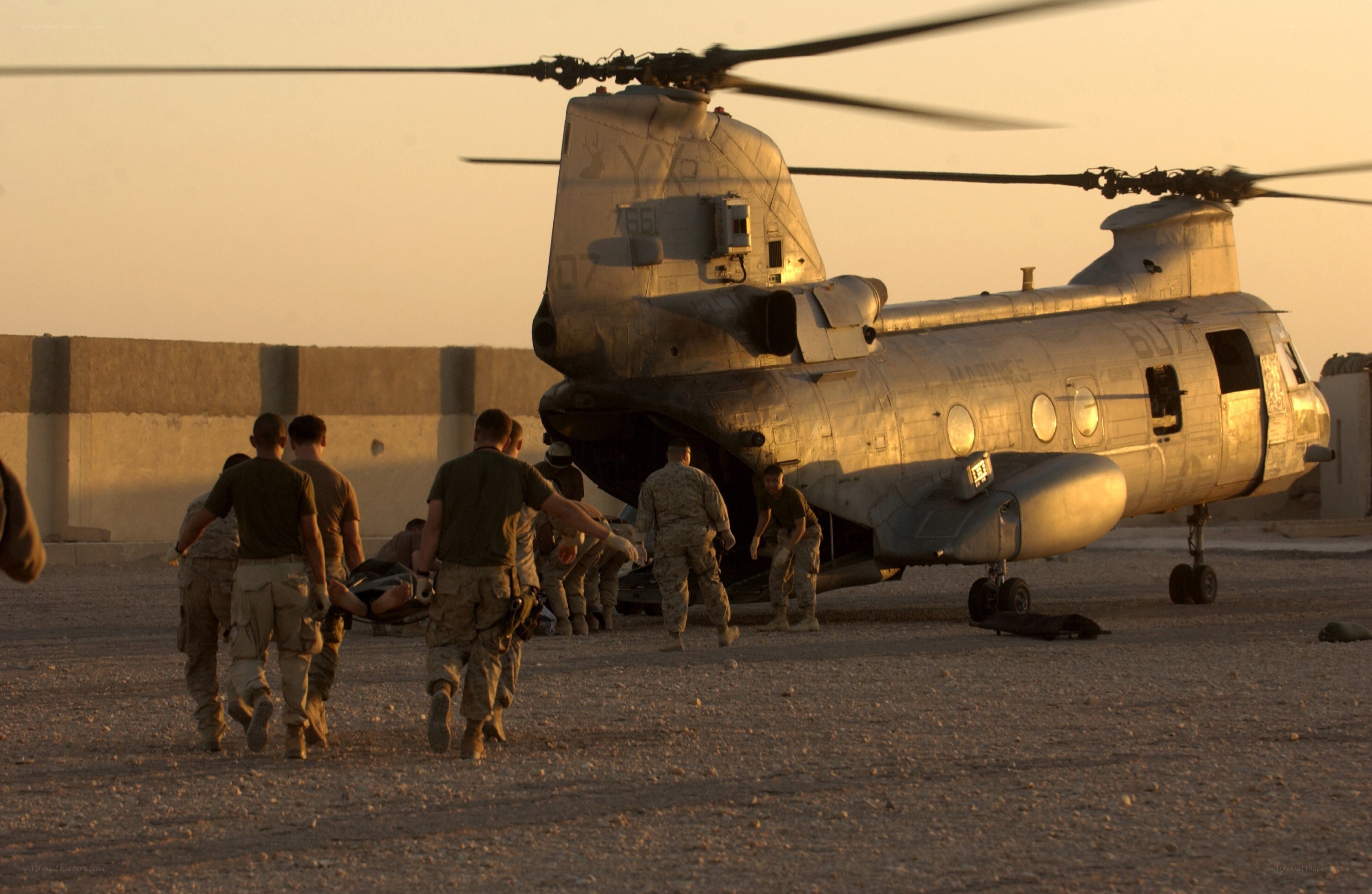 Soldiers evacuating wounded from helicopter