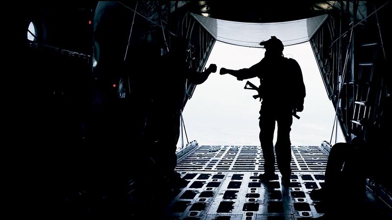 soldiers fist bumping in aircraft