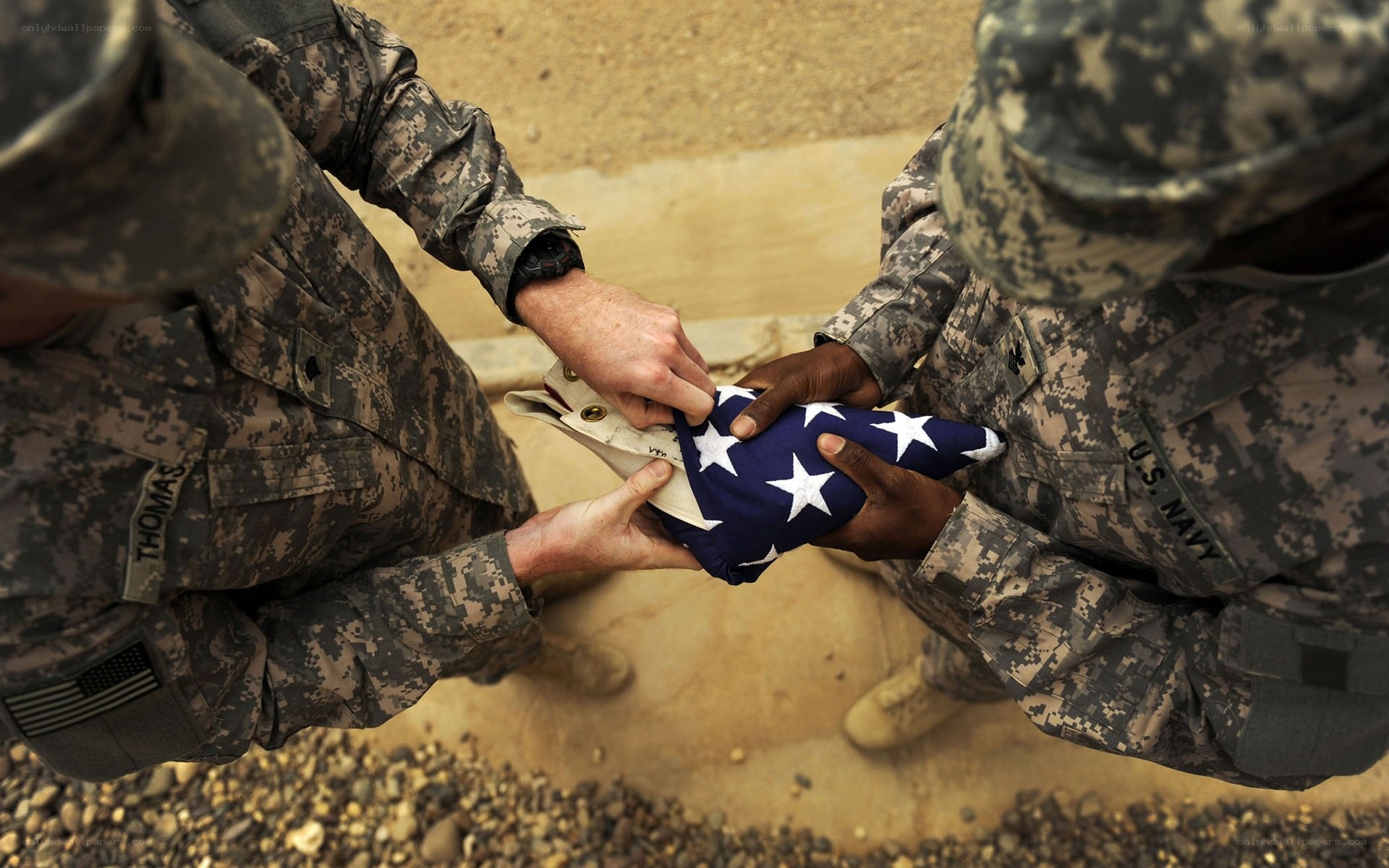 Soldiers folding American flag