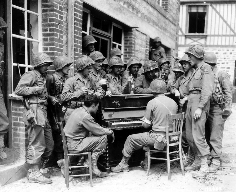 Soldiers gather around piano