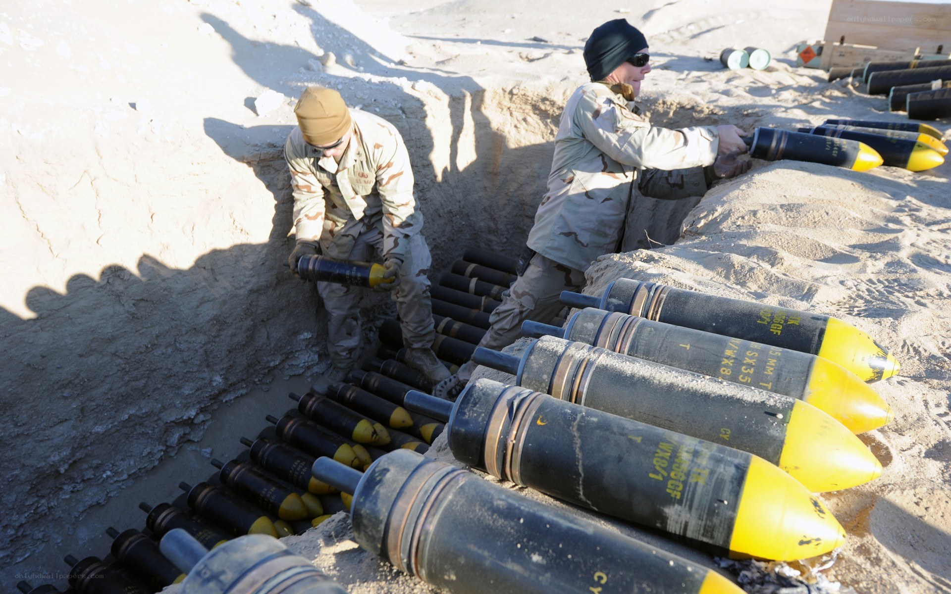 Soldiers handling artillery shells