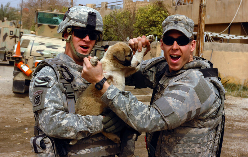Soldiers Holding Puppy