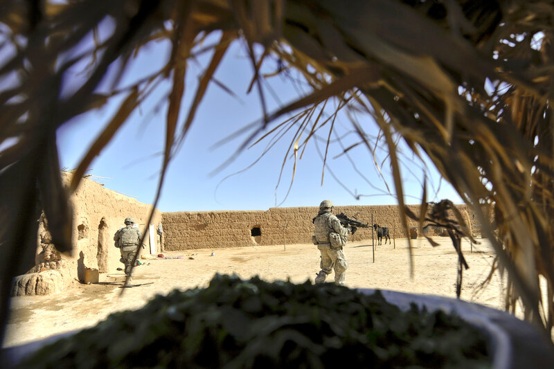 Soldiers in a village courtyard
