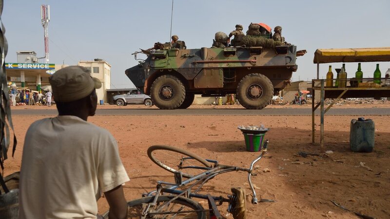 Soldiers in armored vehicle on street