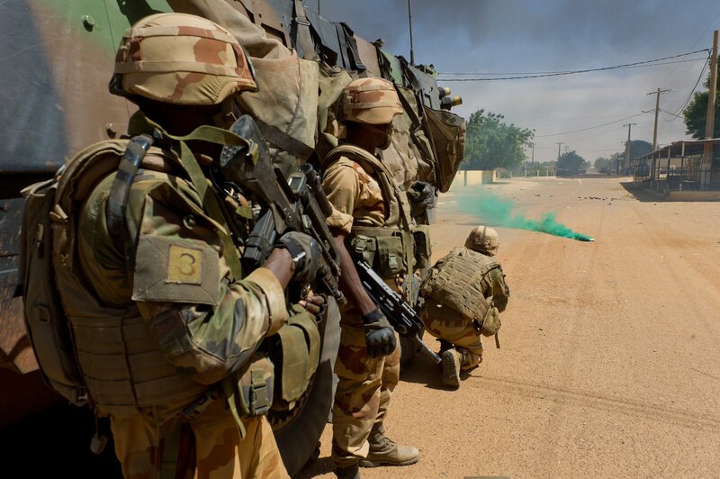 Soldiers in combat gear on street