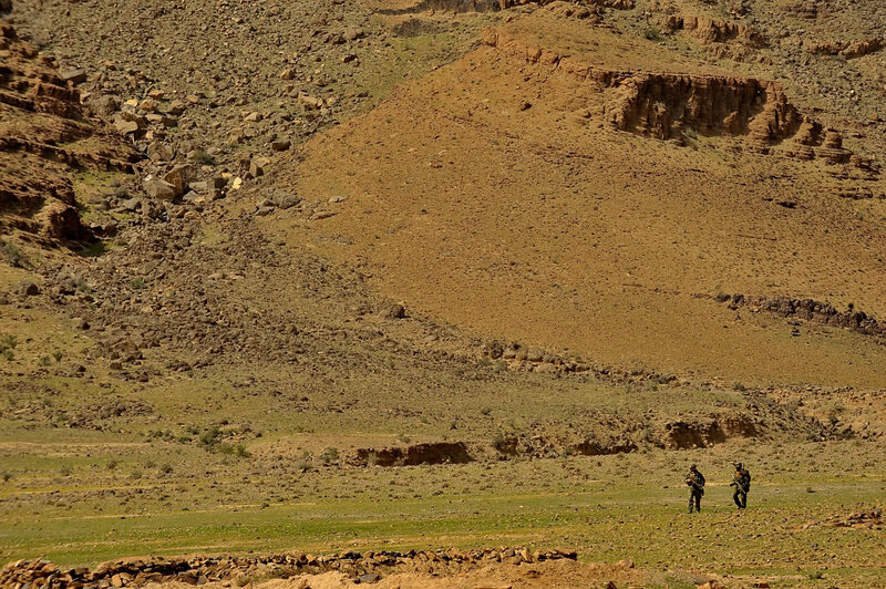 Soldiers in desert terrain