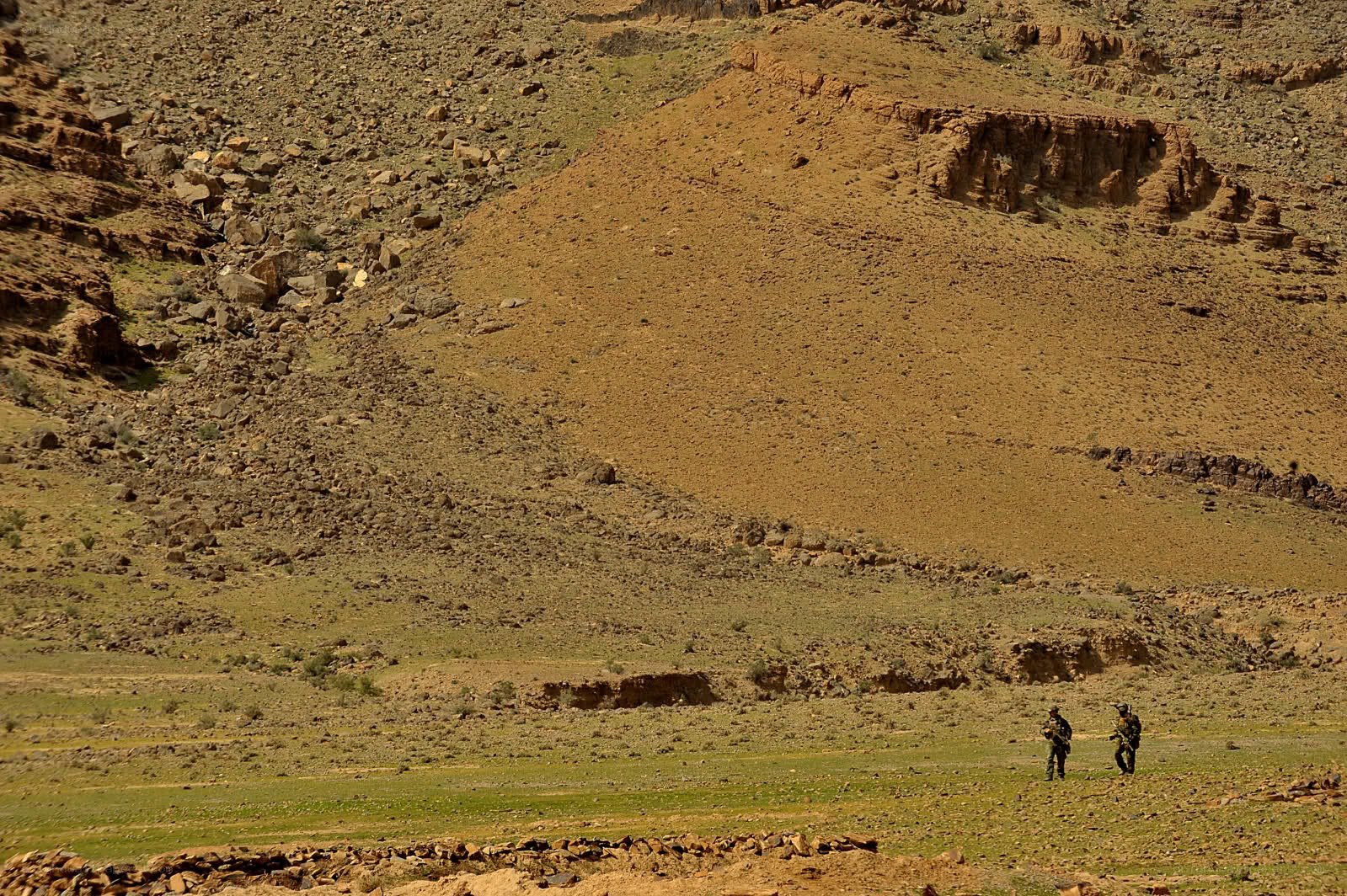 Soldiers in desert terrain