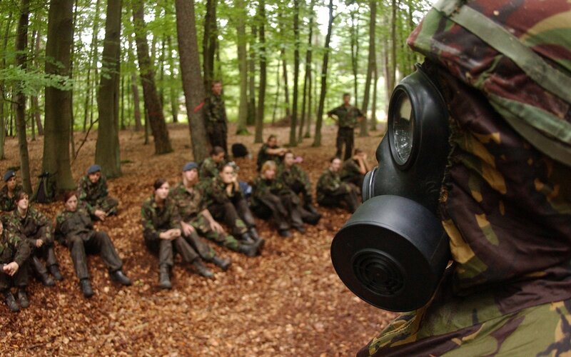 Soldiers in forest with gas mask