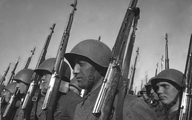Soldiers in formation with rifles