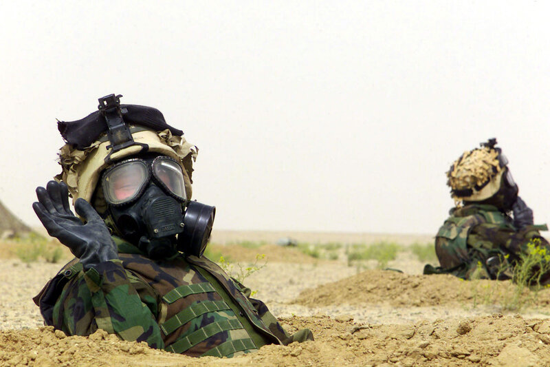 Soldiers in gas masks in desert
