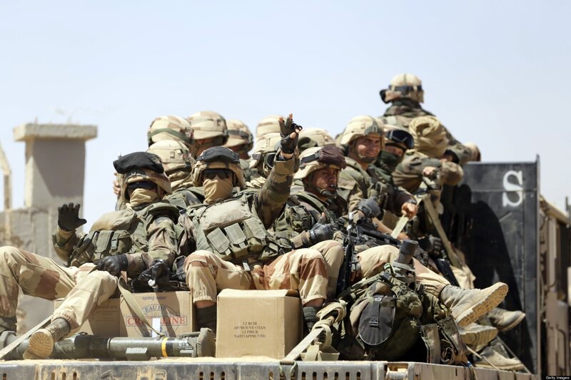 Soldiers in Military Vehicle — Tan, Serious