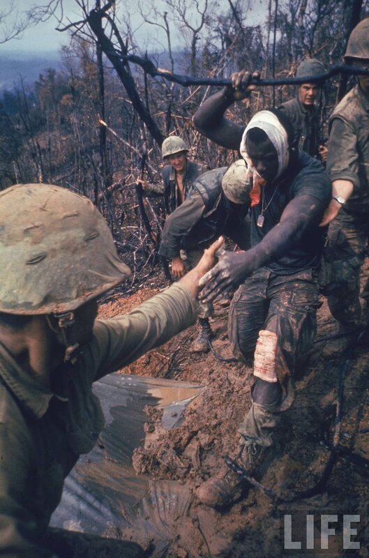Soldiers in muddy terrain