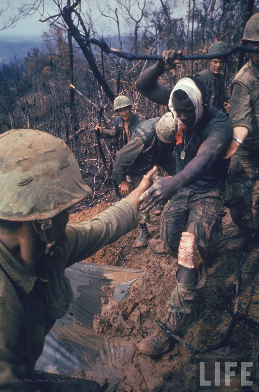 Soldiers in muddy terrain