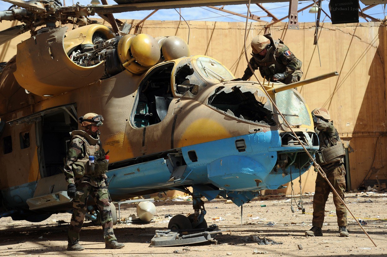 Soldiers inspecting damaged helicopter