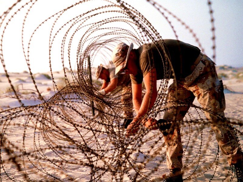 Soldiers installing barbed wire