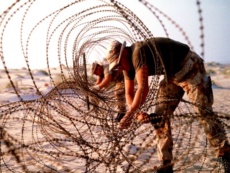 Soldiers installing barbed wire
