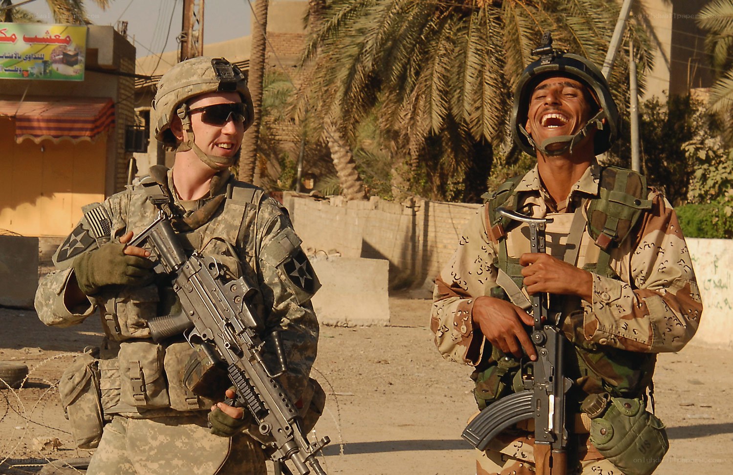 Soldiers laughing in combat zone
