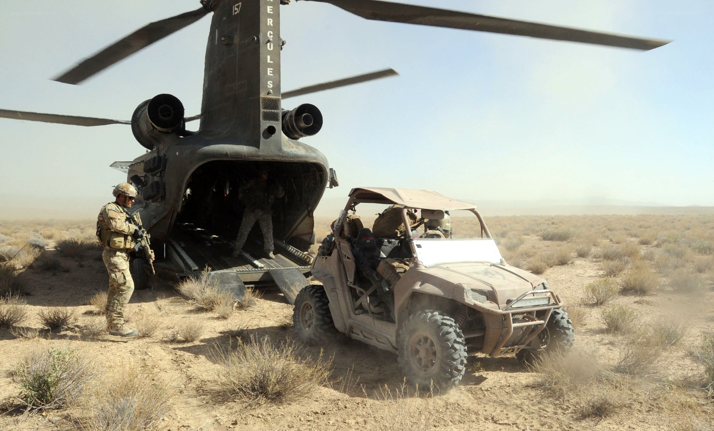 Soldiers loading vehicle into helicopter