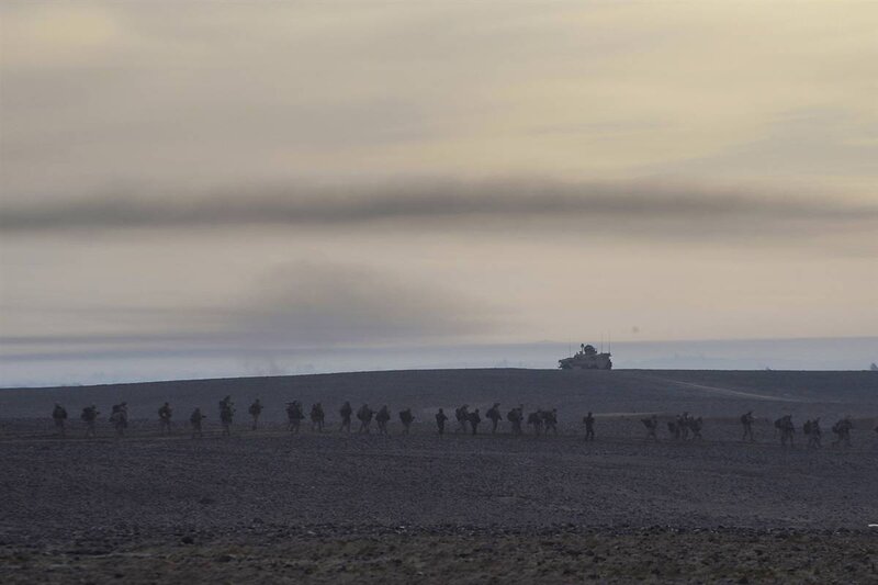 Soldiers marching in desert