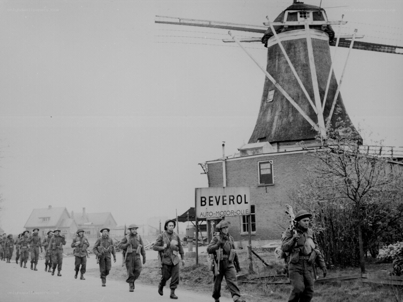 Soldiers marching near a windmill