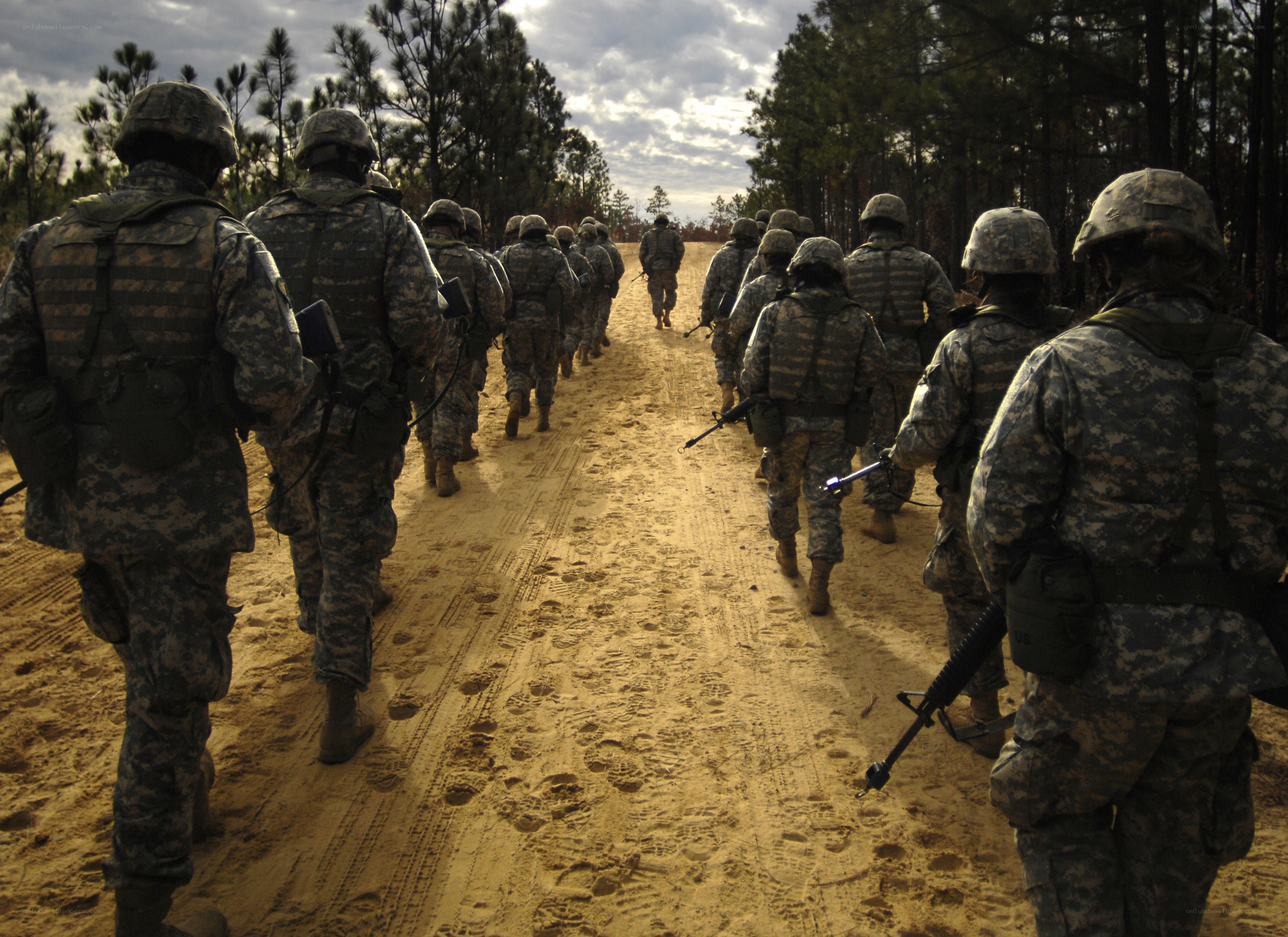 Soldiers marching on a dirt road