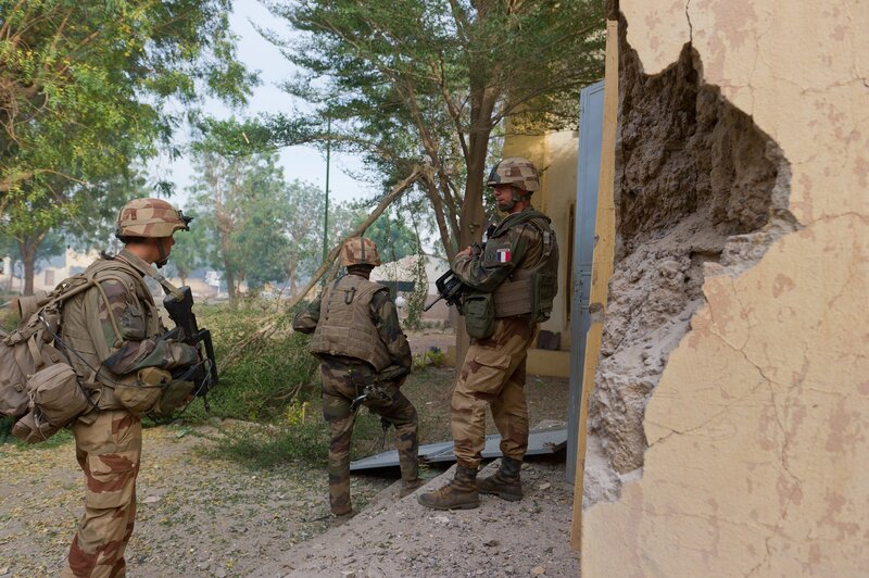 Soldiers near damaged building