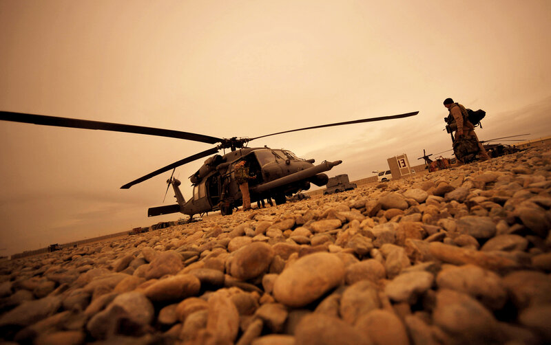 Soldiers near helicopter at airfield
