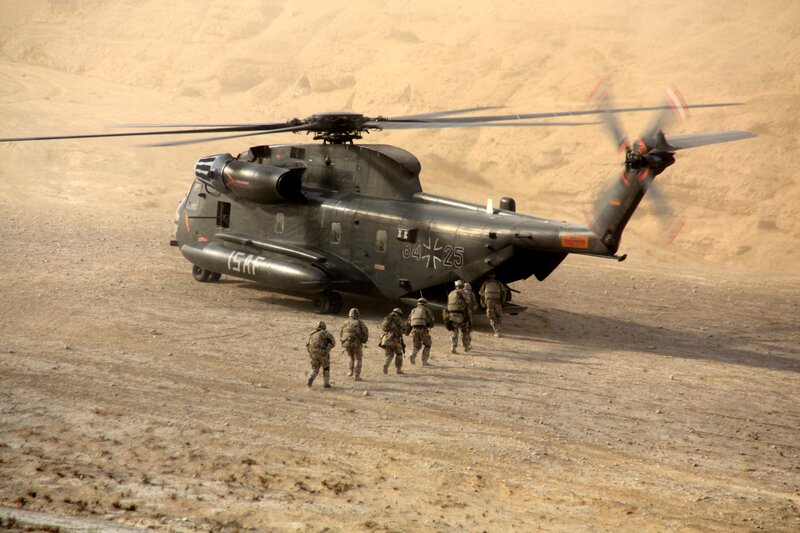 Soldiers near military helicopter