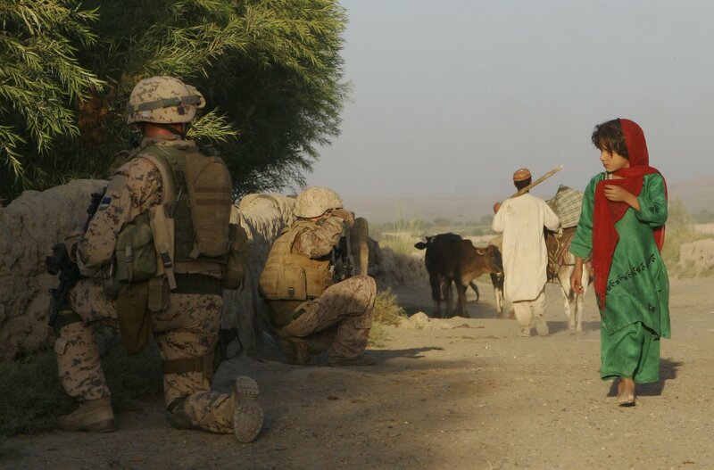 Soldiers observe villagers on a road