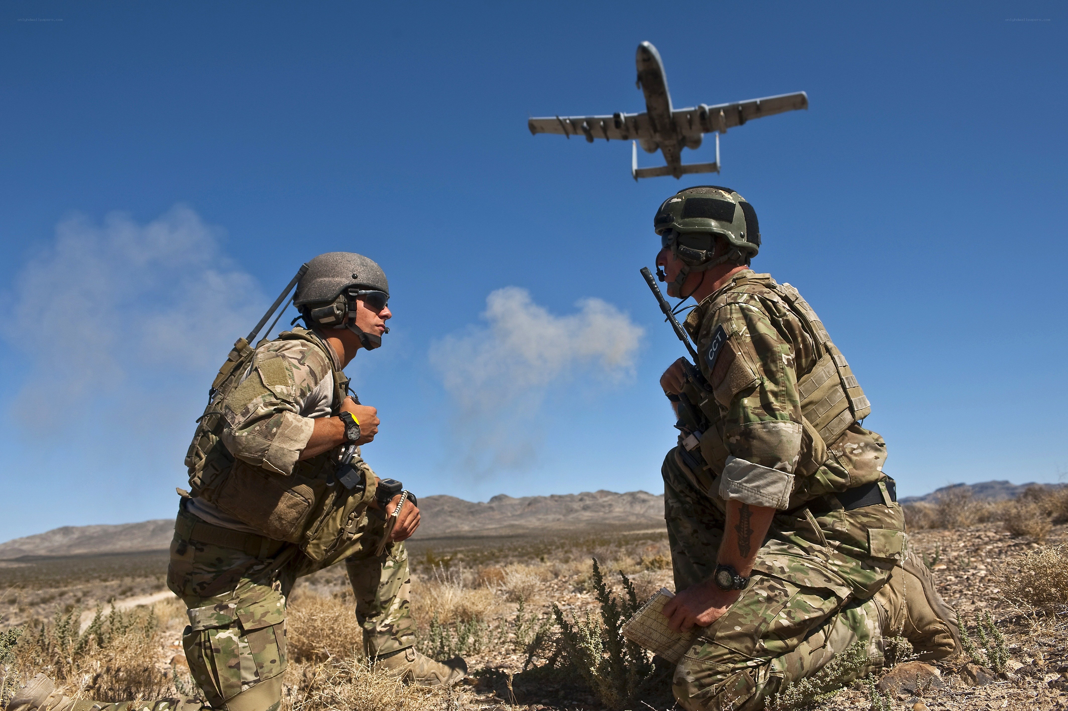 Soldiers observing aircraft in desert