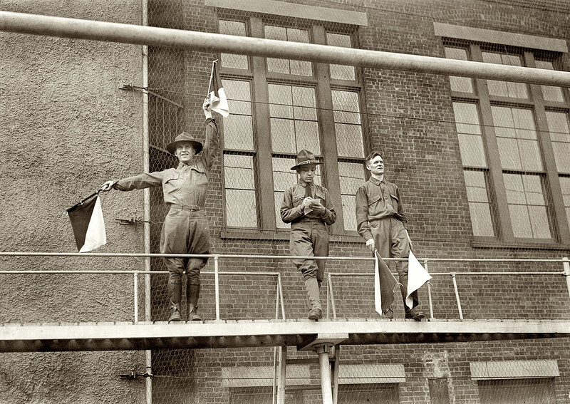 Soldiers on a balcony with flags