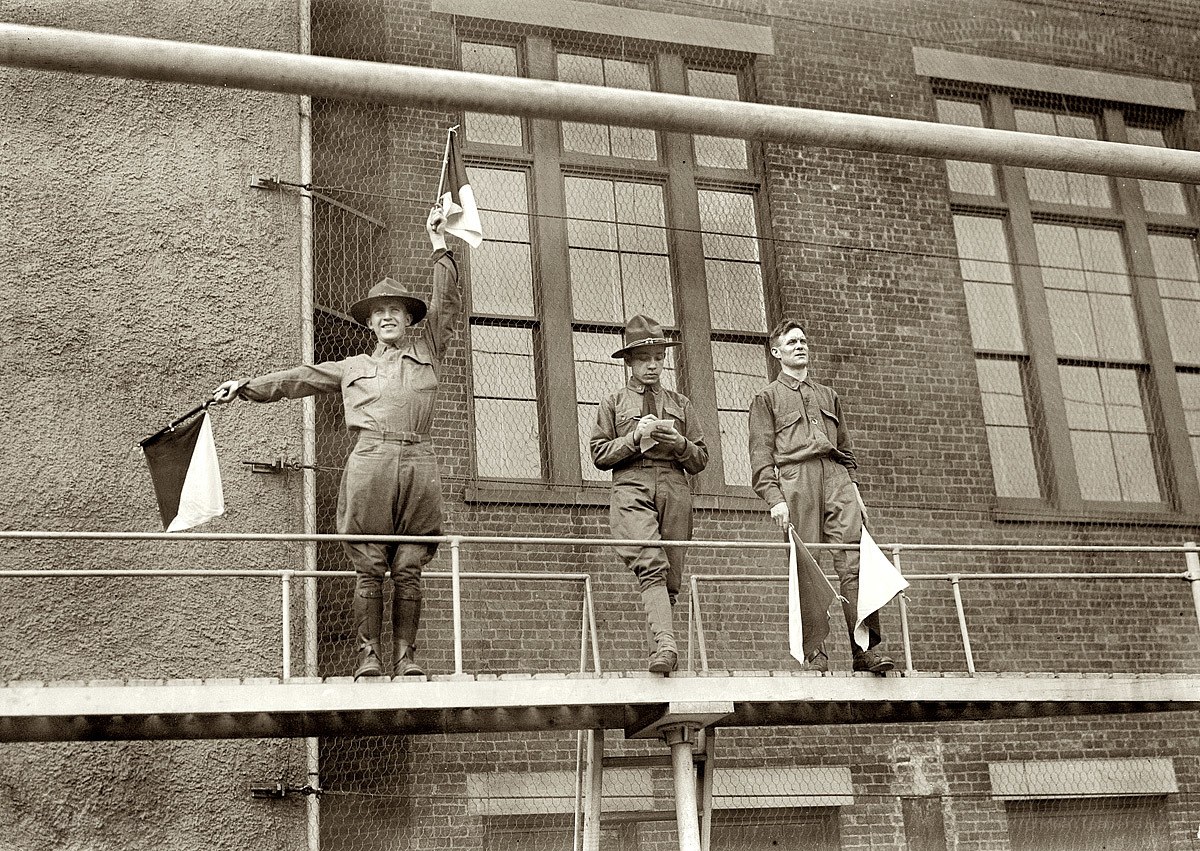 Soldiers on a balcony with flags
