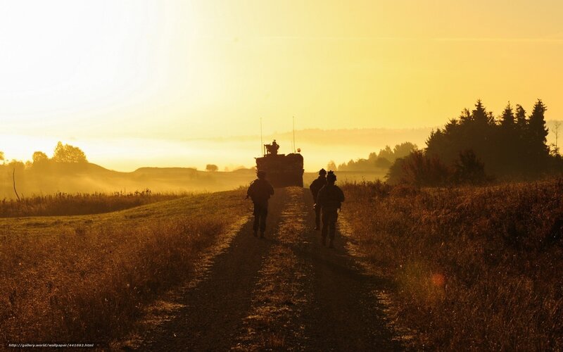 Soldiers on a dirt path at sunrise