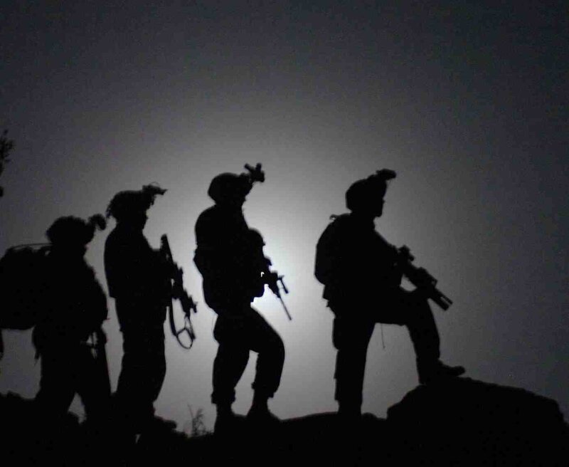 soldiers on a hill at night