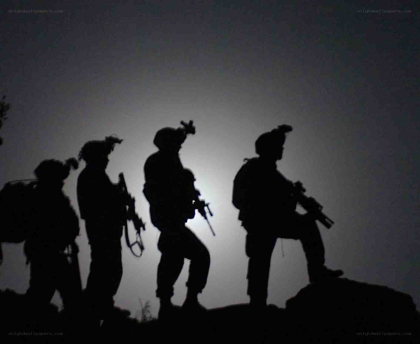 soldiers on a hill at night
