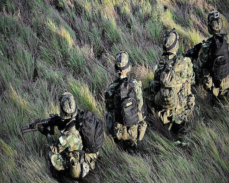 Soldiers on a hillside patrol