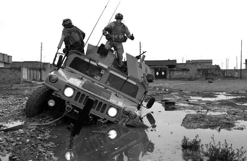 Soldiers on a stuck military vehicle