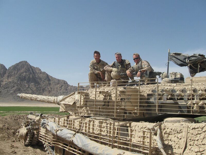 Soldiers on a tank in desert