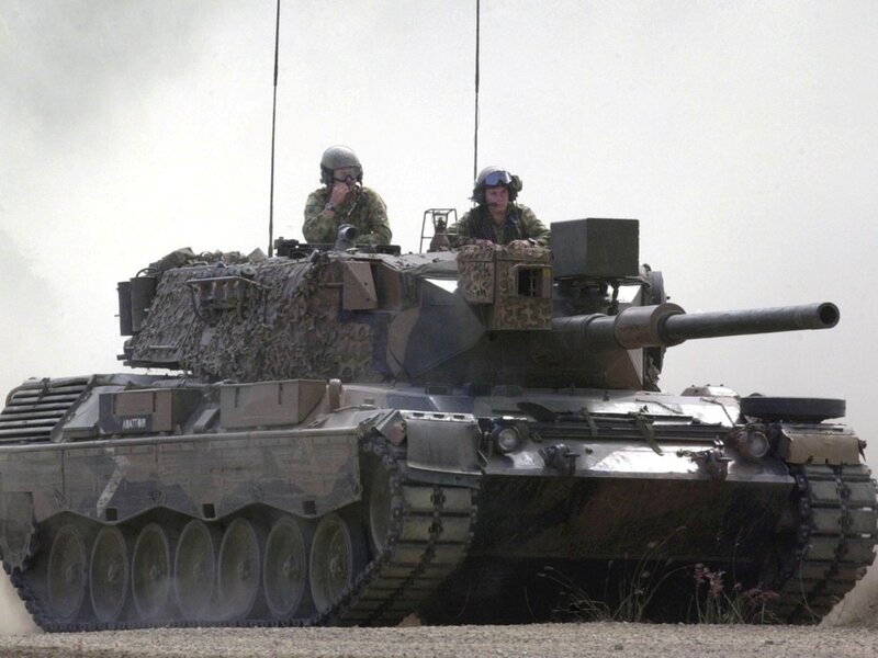 Soldiers on a tank in desert