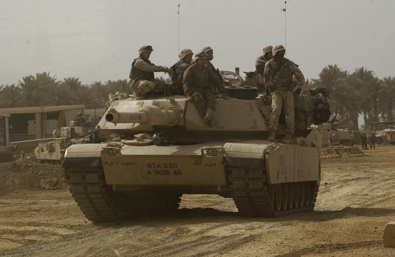 Soldiers on a tank in desert