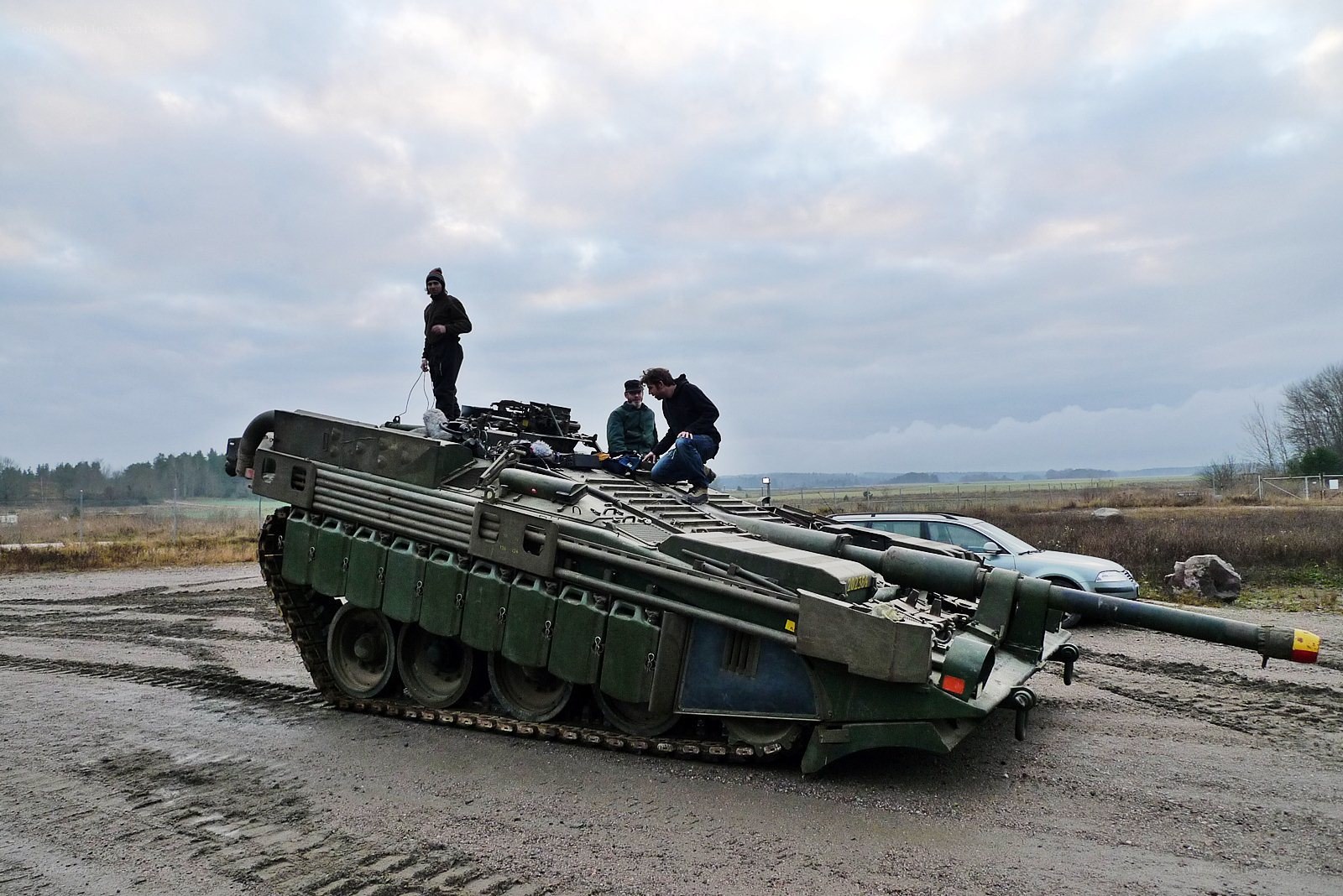 Soldiers on a tank in field