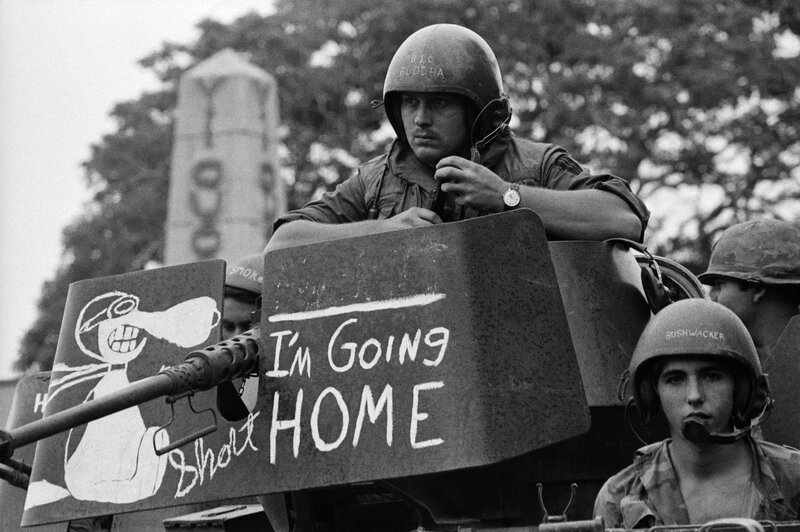 Soldiers on a tank with graffiti