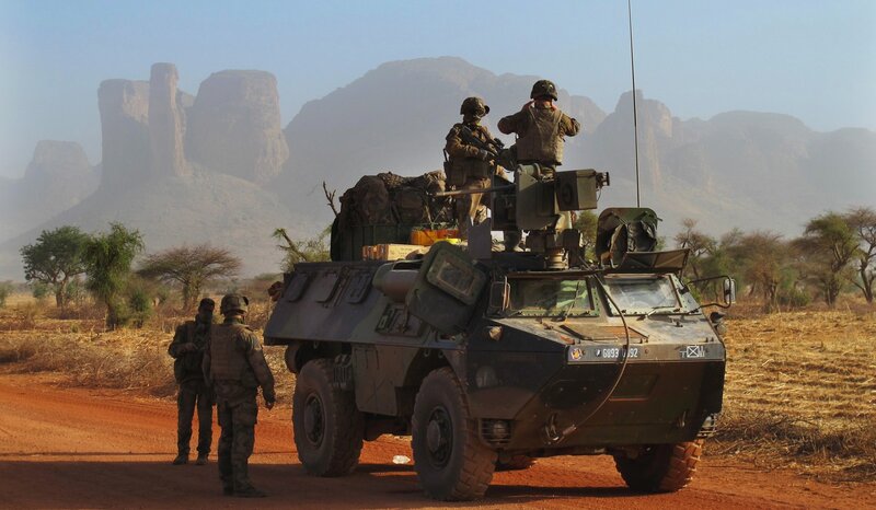 Soldiers on armored vehicle in desert