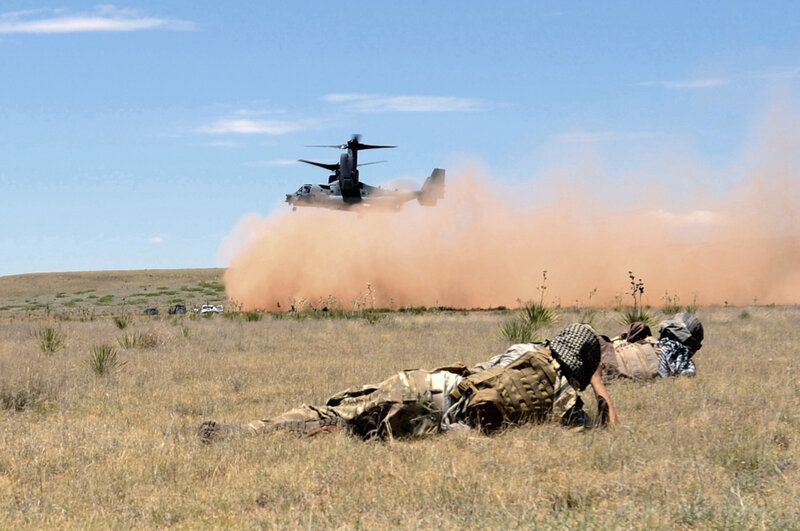 Soldiers on ground as helicopter lands