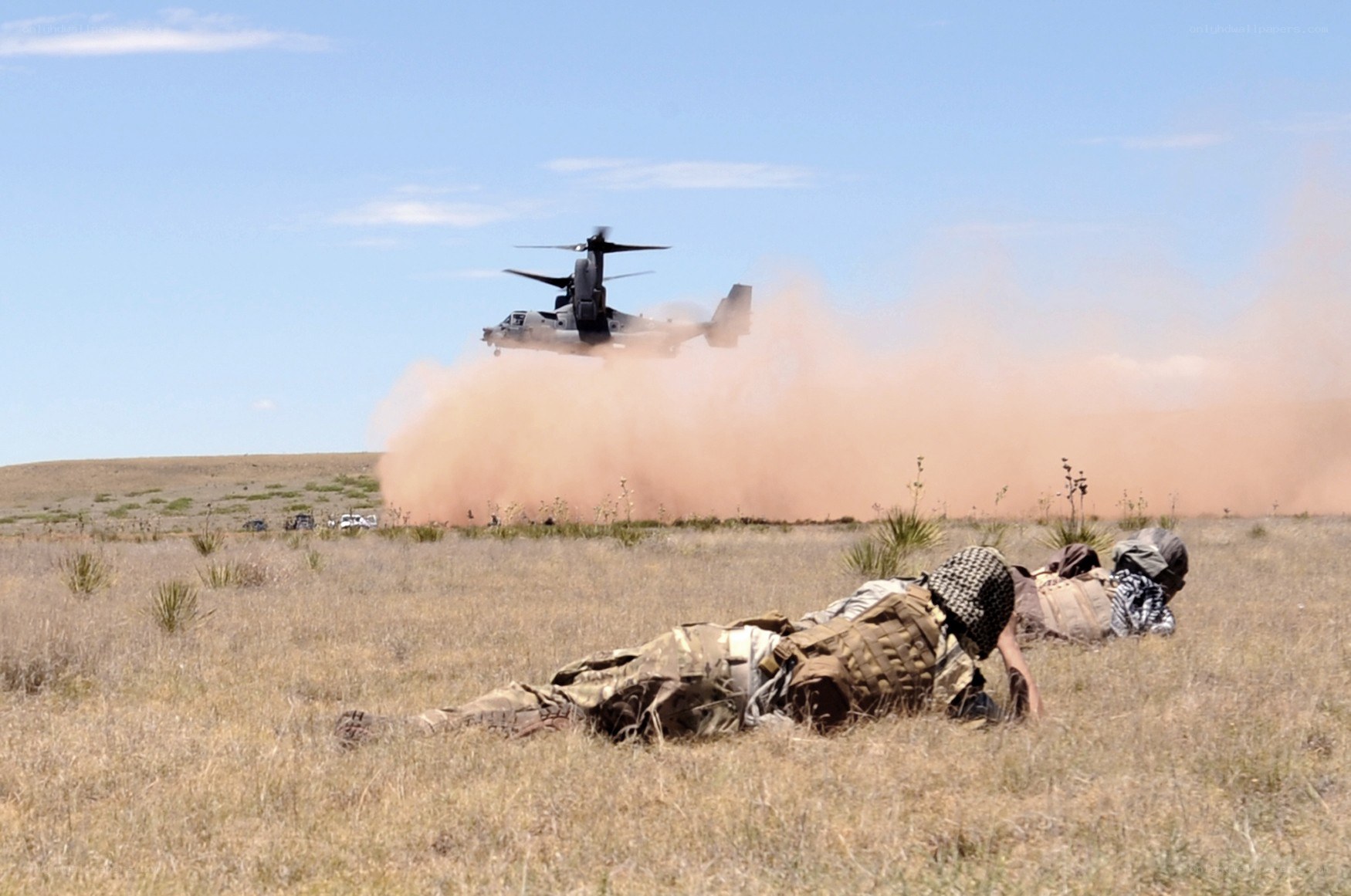 Soldiers on ground with helicopter